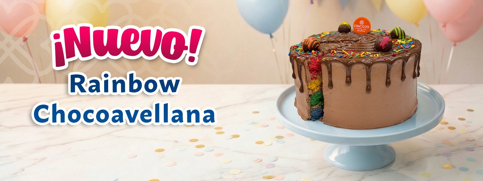 Rainbow Chocoavellana cake on blue pedestal with ¡Nuevo! banner and colorful balloons on festive background